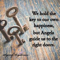 two old keys sitting next to each other on a wooden surface with the words we hold the key to our own happiness, but angels guide us to the right doors