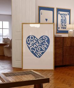 there is a large blue heart with words on it in the middle of a room