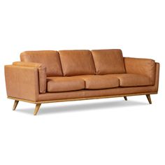 a tan leather couch with wooden legs