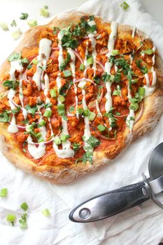 a pizza sitting on top of a table covered in sauce and veggie toppings