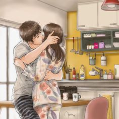 a man and woman hug in the kitchen