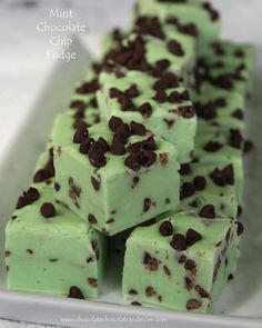 mint chocolate chip fudge bars stacked on top of each other in a white tray