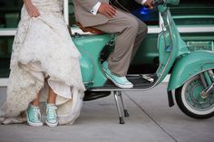 a bride and groom are sitting on a scooter