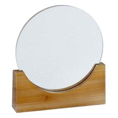 a white plate sitting on top of a wooden stand in front of a white background