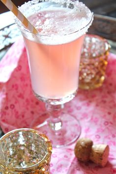 a pink drink in a glass with a straw