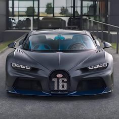 the bugatti supercar is parked in front of a building