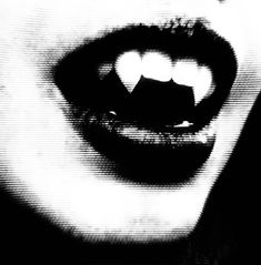 a black and white photo of a woman's face with her mouth open in half