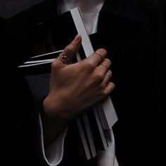 a woman with her hands folded around some books