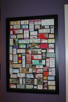 a purple wall covered in lots of different types of business cards and magnets on it