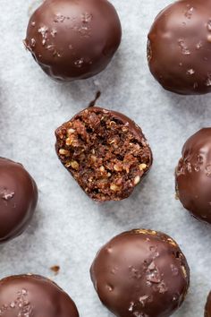 chocolate covered donuts with nuts on top