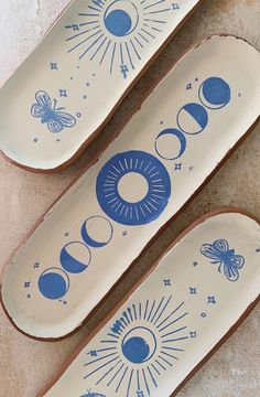 three skateboards with designs on them sitting on the ground