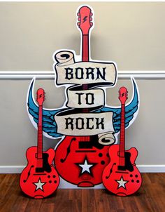 a sign that says born to rock with guitars