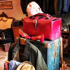 a pile of suitcases and hats sitting on top of each other in a room