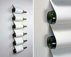 the wine bottles are hanging on the wall next to the paper rollers that hold them