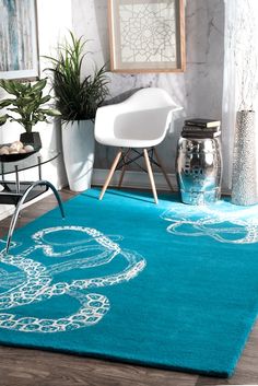 a blue rug with an elephant drawn on it in the middle of a living room