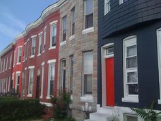 two red doors are on the side of this row of houses