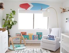 a child's room with surfboards on the wall, and a rocking chair