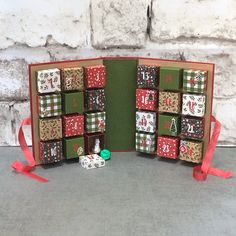 an open christmas card with lots of presents on it and red ribbon around the edges