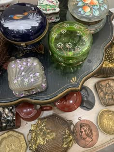 a table topped with lots of different colored plates