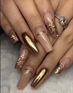 some gold and pink nail designs on someone's nails with glitters in them