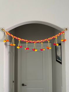 a doorway decorated with colorful tassels and decorations