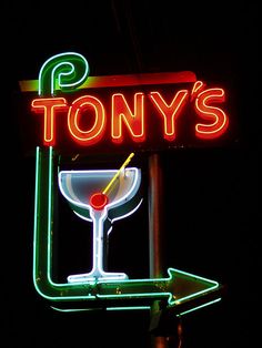 a neon sign that says tony's with a martini in it