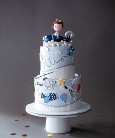 a three tiered cake with an image of a baby on top