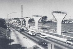 an old black and white photo of traffic on the freeway