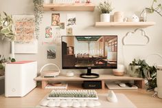 a computer monitor sitting on top of a wooden desk