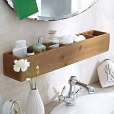 a bathroom sink with a wooden shelf above it