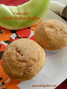 two muffins sitting on top of a white plate