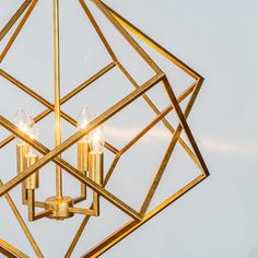 a golden chandelier with three candles in it