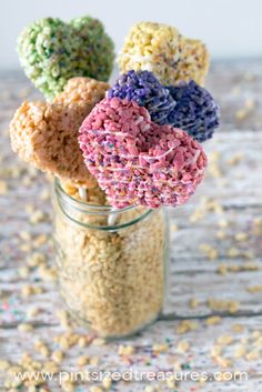 some rice krispy treats are in a jar with sprinkles on it