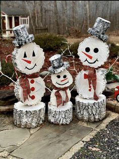 three snowmen with hats and scarfs on their heads are made out of tin foil