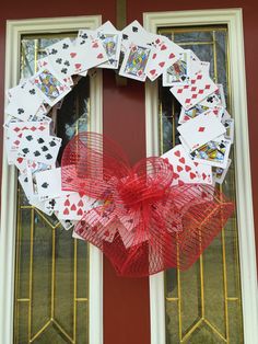 a wreath made out of playing cards on the front door