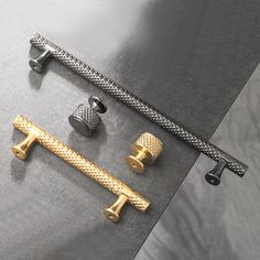 three different types of knobs and handles on a metal surface