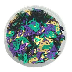 a white bowl filled with lots of purple and green confetti