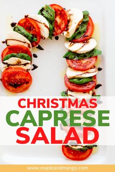 a christmas caprese salad with tomatoes and mozzarella cheese on the side