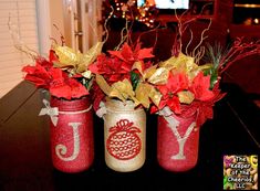 three jars with christmas decorations in them sitting on a table