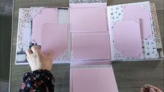 someone is cutting out pink paper with scissors