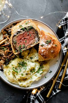 a plate with some meat and mashed potatoes on it