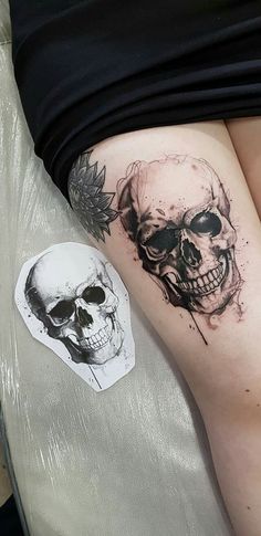 a woman's thigh with a skull tattoo on it