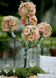 the centerpiece is made out of moss and pink roses