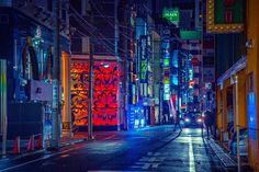 an empty city street at night with neon lights