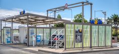 a car is parked in front of a gas station with an awning over it