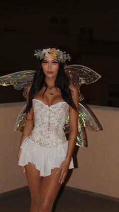 a woman in a white corset and fairy wings