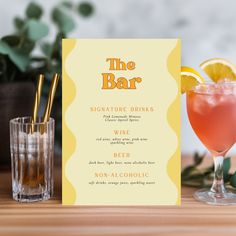 the bar menu is next to two glasses with drinks