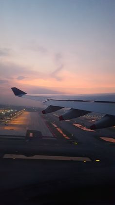 the wing of an airplane as it is about to take off at sunset or dawn