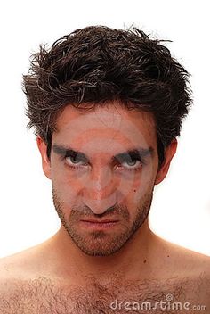 a shirtless man with his face painted white and black, looking at the camera