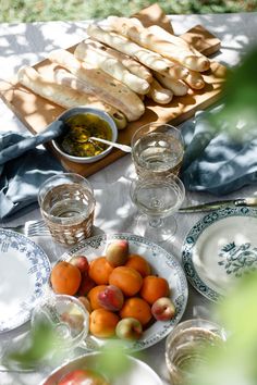 the table is set with bread, fruit and water